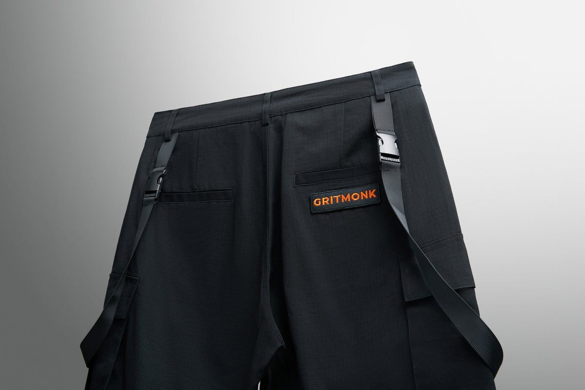 GRITMONK TRAIL black wide-leg cargo: angled back view, straps and patch