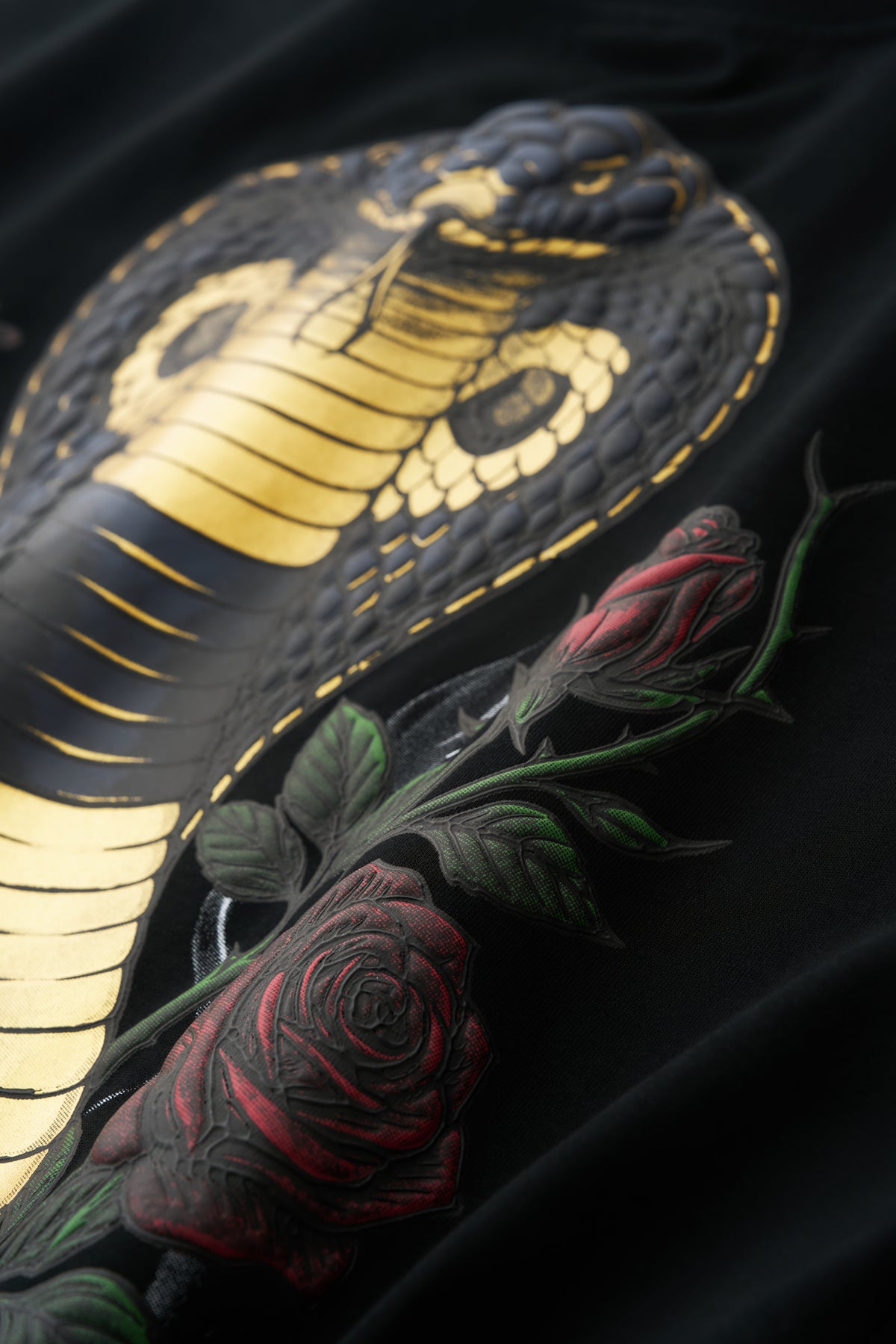 GRITMONK VENOM black oversized tee: close-up of the metallic gold cobra and roses